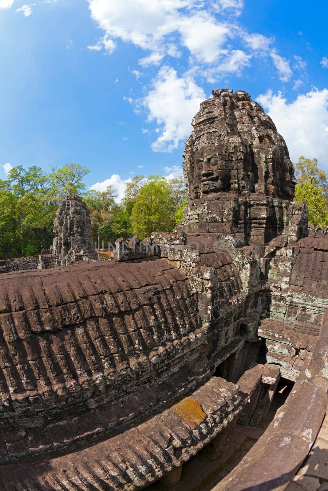Massive stone faces decorating towers of Bayon temple in Angkor Thom, Cambodia