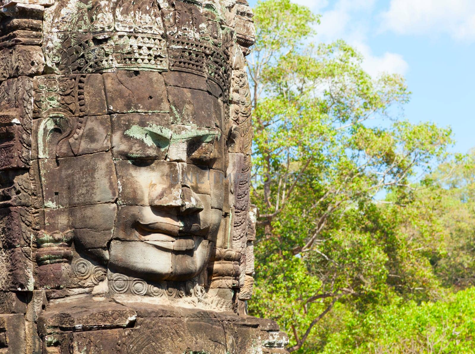 Massive stone faces decorating towers of Bayon temple in Angkor Thom, Cambodia