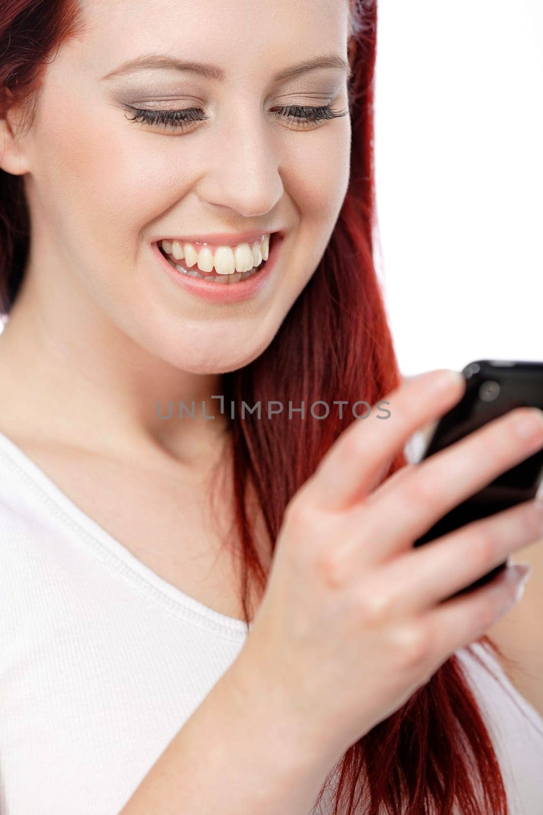 Happy smiling young woman reading texts and laughing.