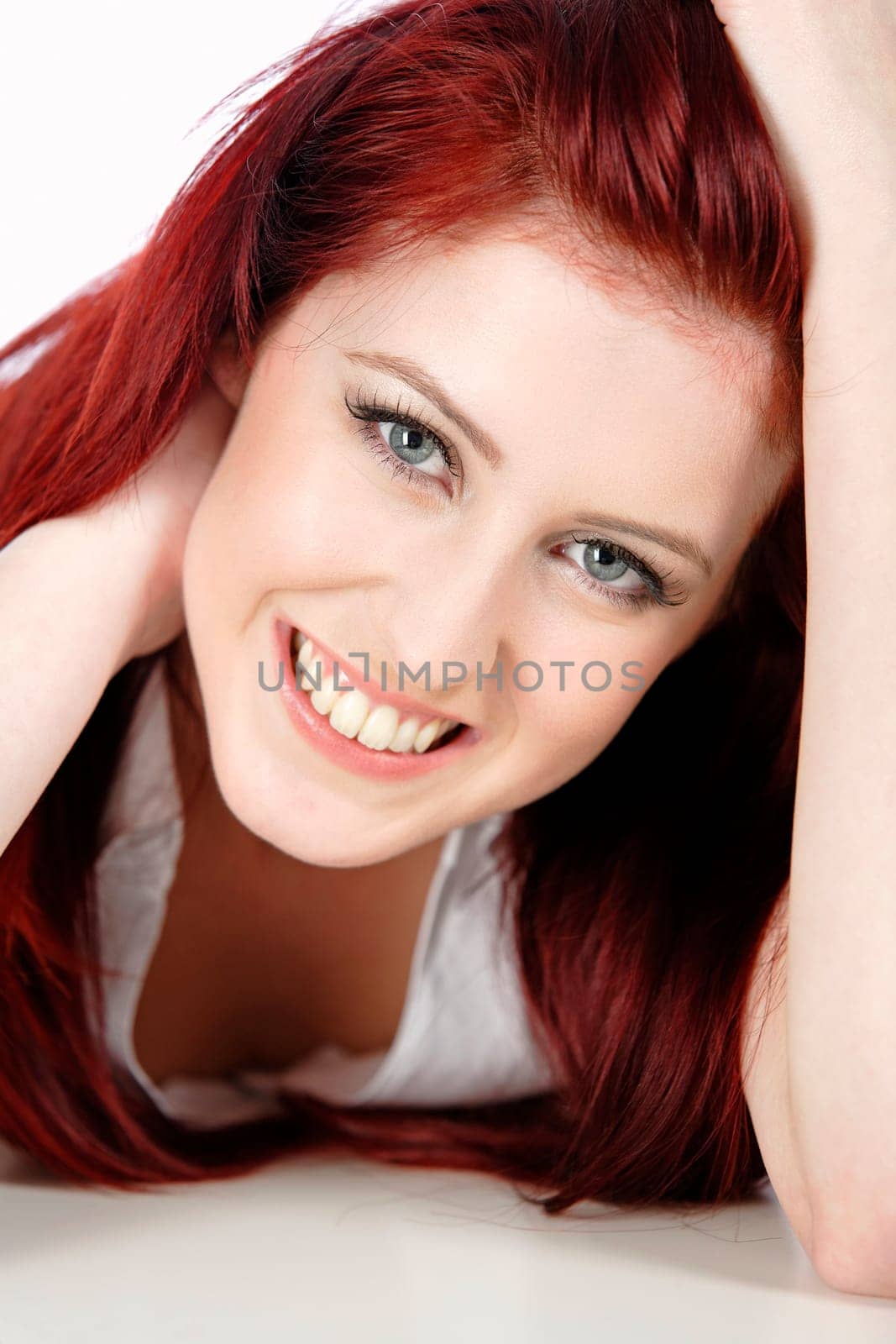 Sexy womans face with long red hair smiling