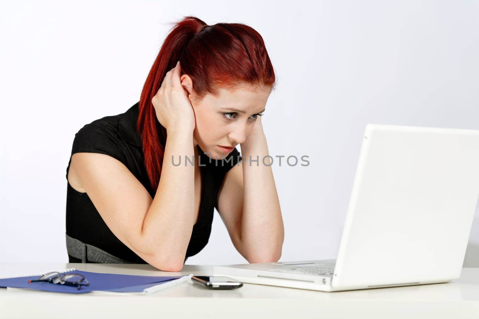 Professional woman showing concern at work using her laptop