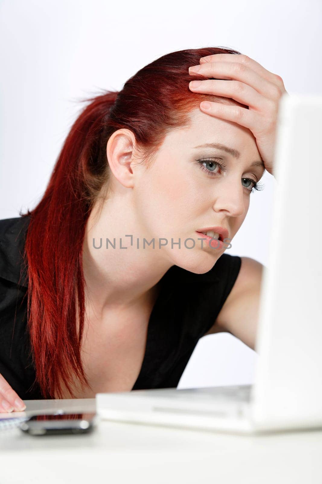 Professional woman showing concern at work using her laptop
