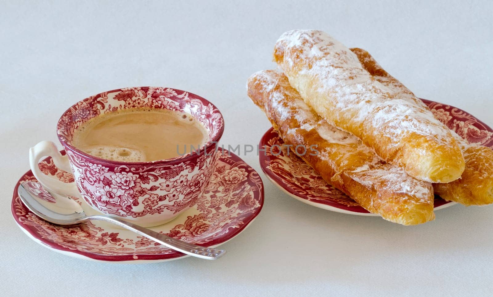 Coffee with milk, with fartons, buns species typical of Valencia, Spain