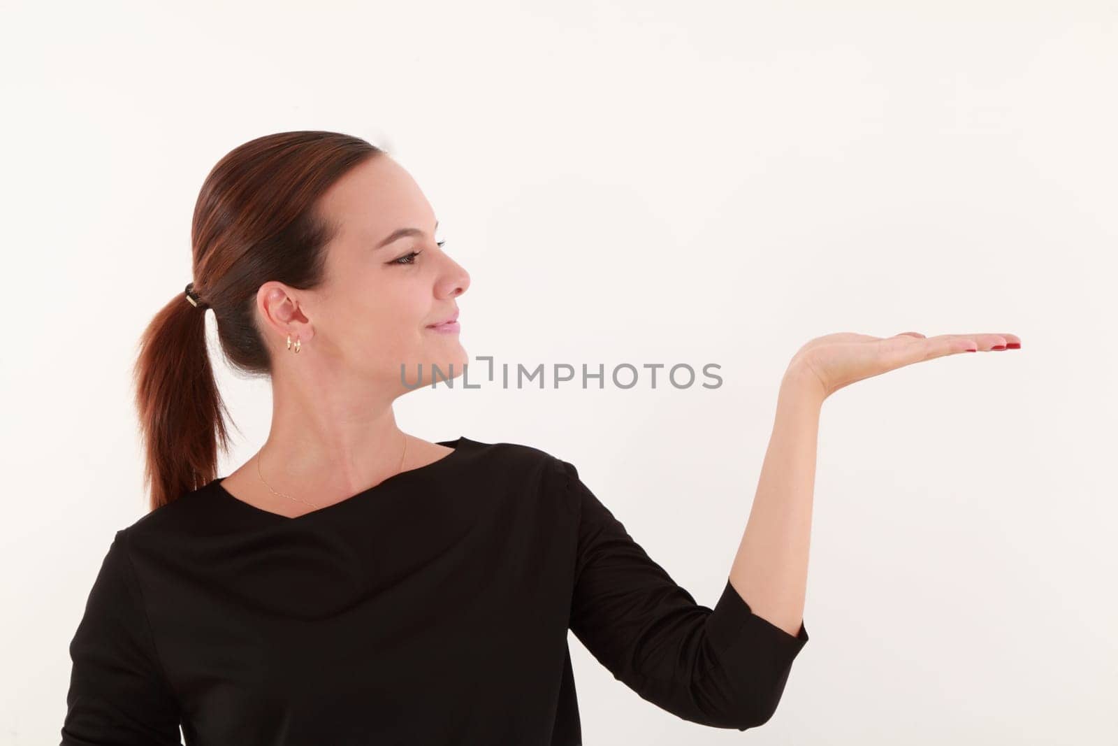 Young beautiful woman holding with flat hand
