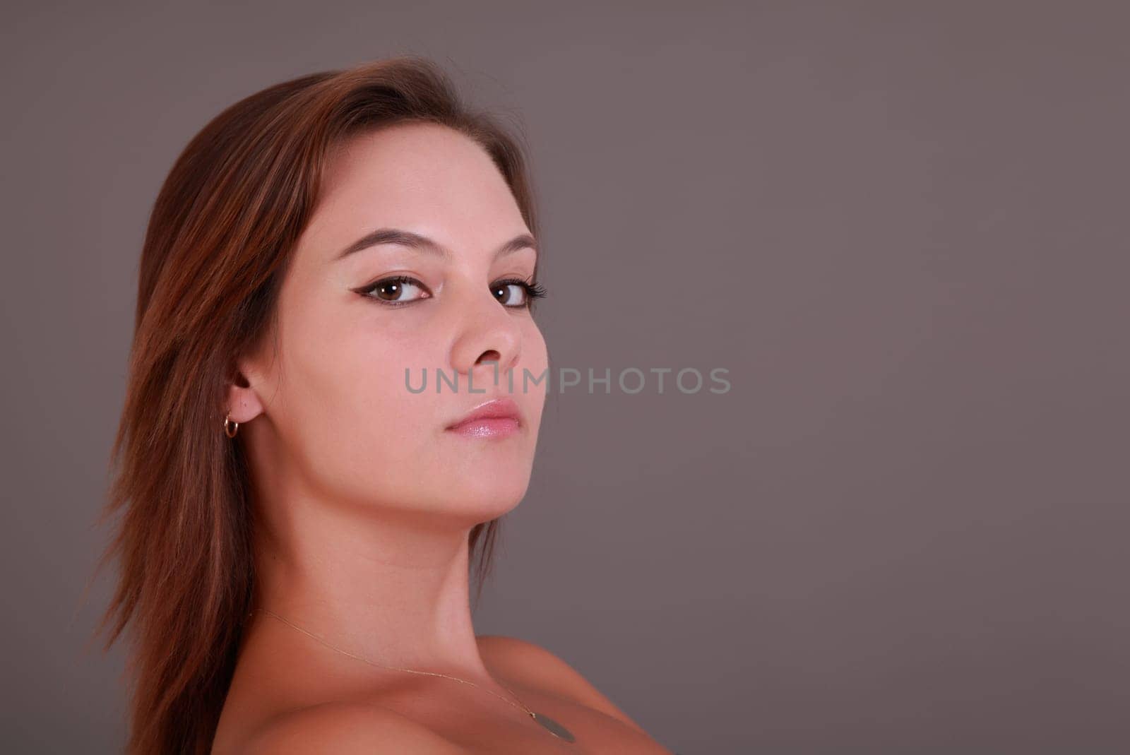 Beautiful girl looking in the camera in serious mood