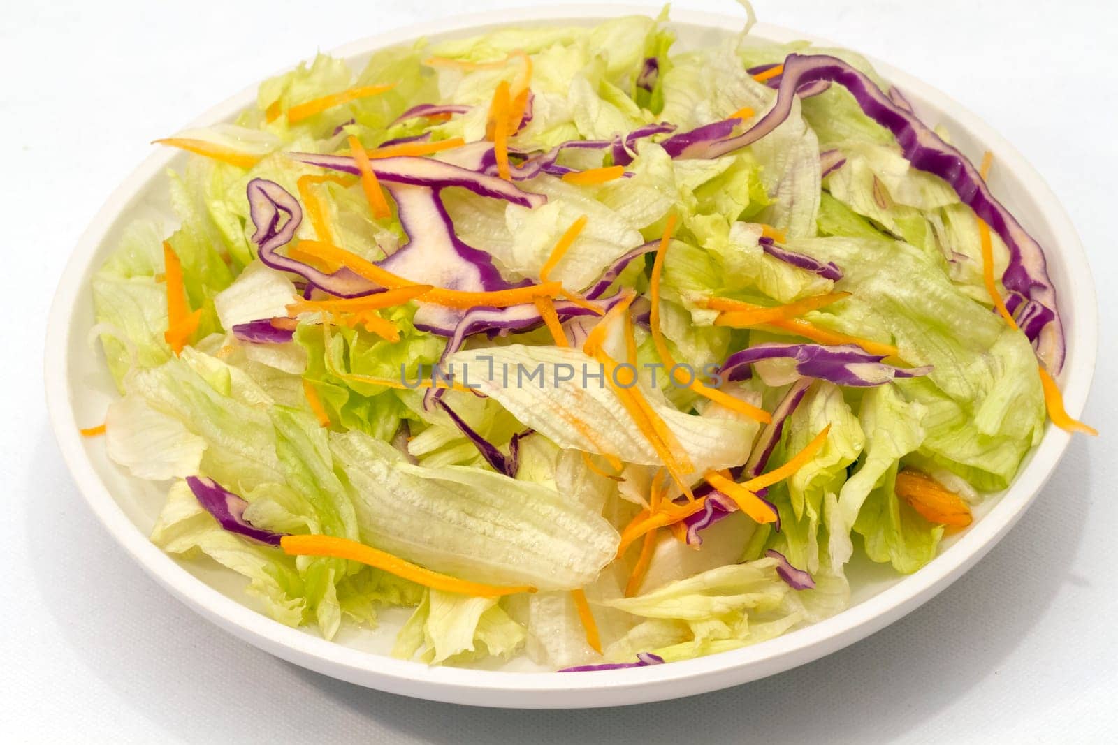 mixed salad presented in plate. Lettuce beet and carrot freshly cut.