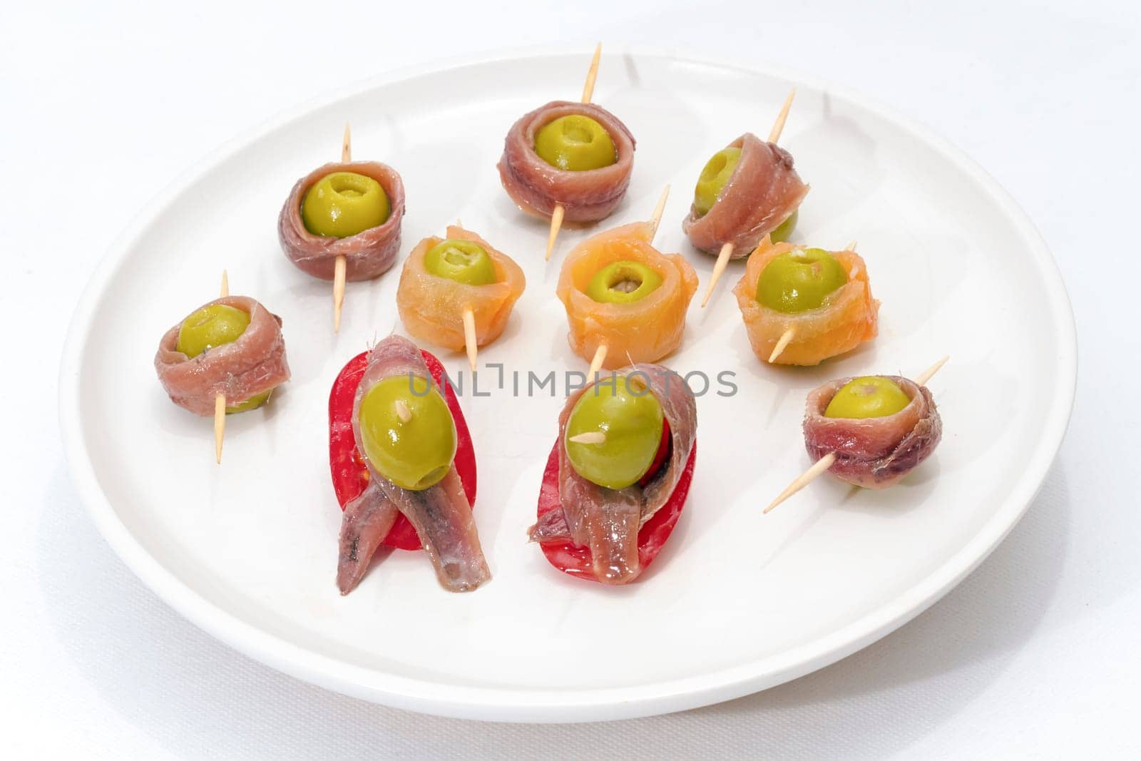 Delicious Appetizer Plate with Salmon, anchovies and Olives