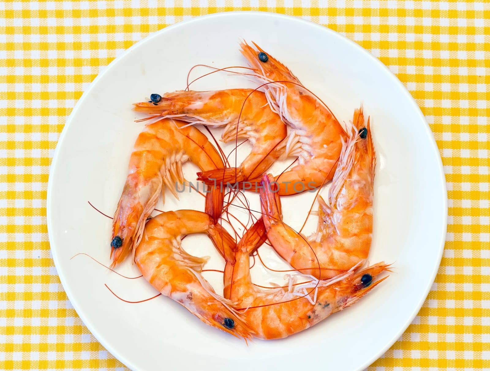 Pile of cooked and peeled shrimp. Presented in plate