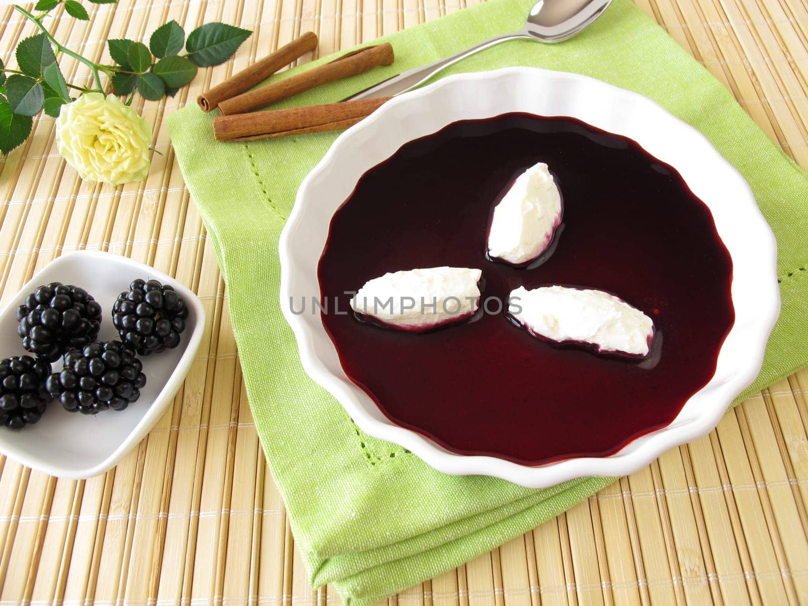 Sweet blackberry soup with curd cheese