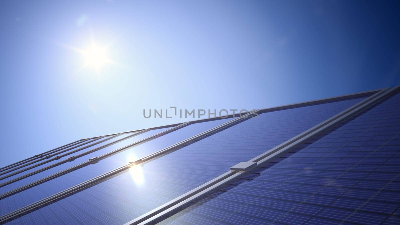 Close-up of a solar panel showing the sun in a clear deep blue sky with reflection off the panel.