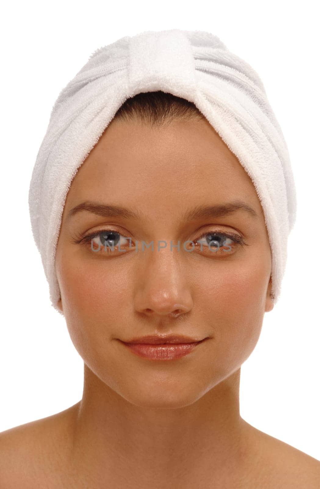 Head shot of a pretty young woman with a spa turban on a white background