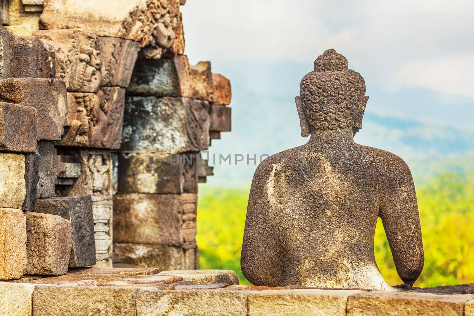 Buddha statue. Mountain on background. Borobudur. Java. Indonesia