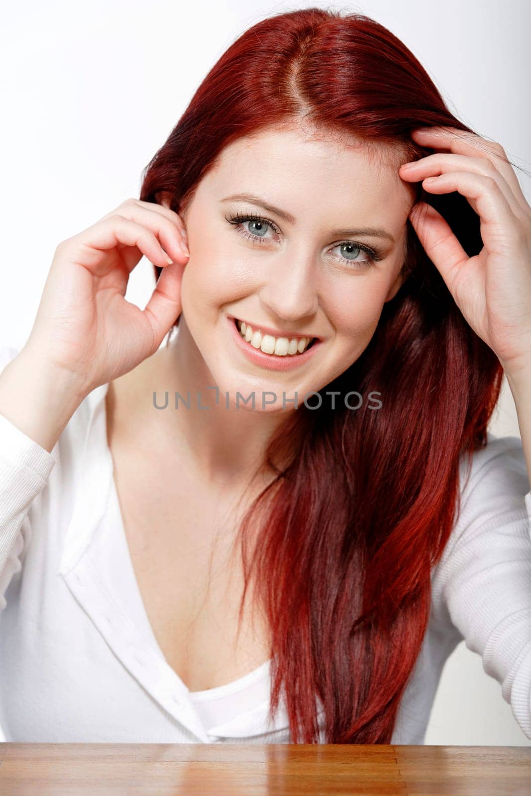 Beautiful young woman resting on a coffee table in front of sofa at home.