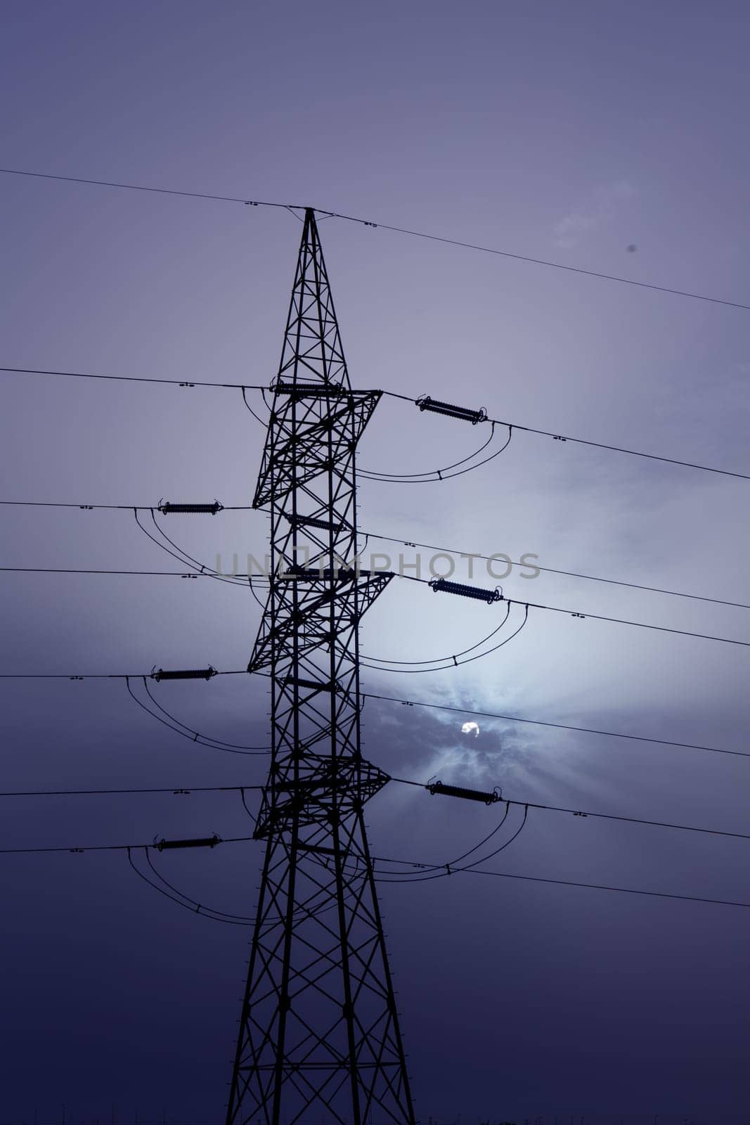 Dramatic clouds sky and electric tower backlight silhouette