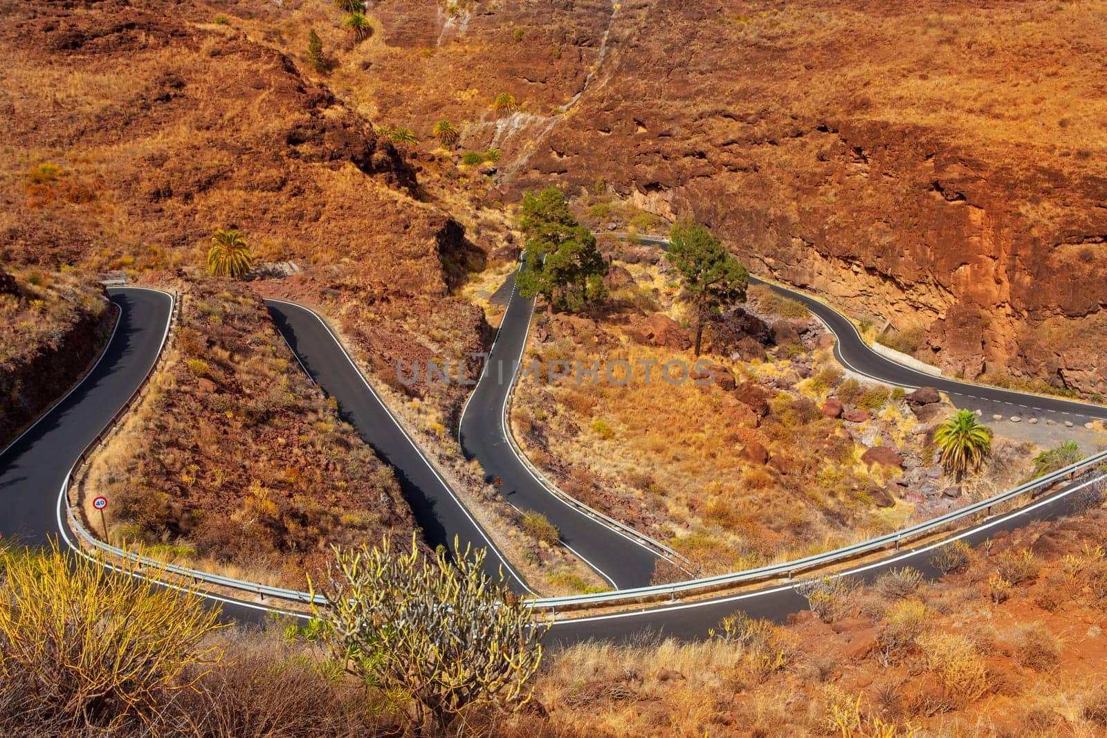 curves winding road high view in red mountains in gran canaria