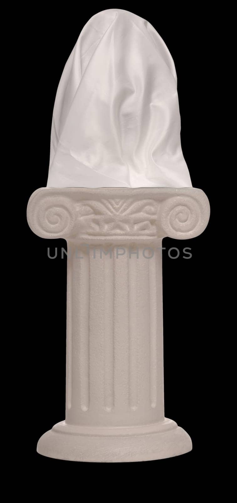 Stone pillar supporting a veiled object on a black background