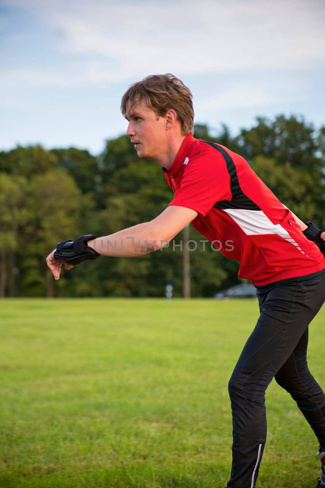 Young sportsman on roller skates make some movements
