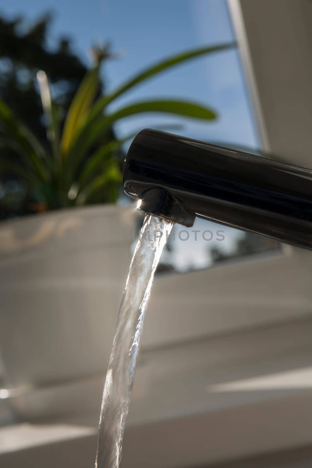 Chromed faucet is opened and release water stream