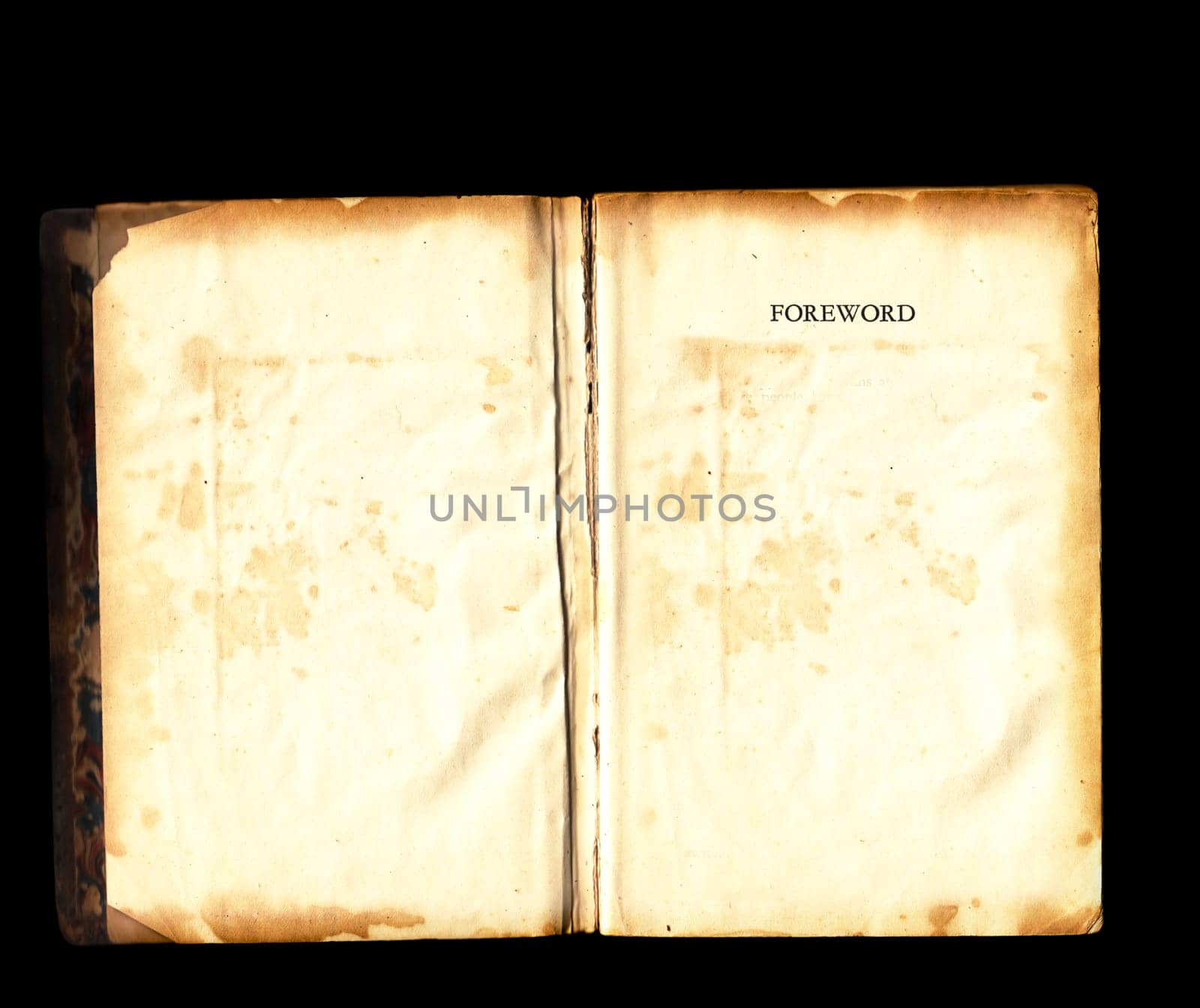 Old tattered vintage book damaged torn open blank pages over black background