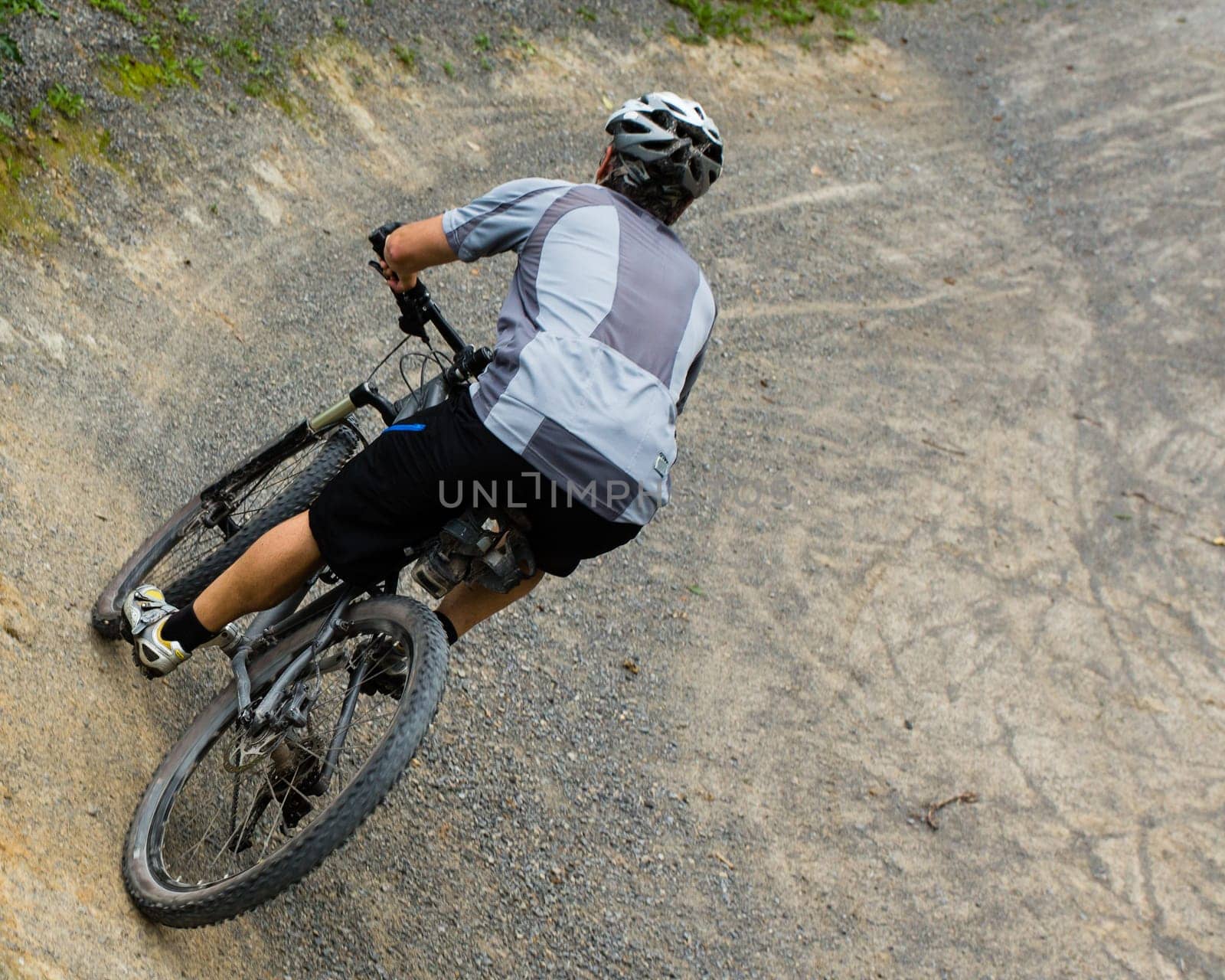 Mountain bikers in an inclined position on the downhill