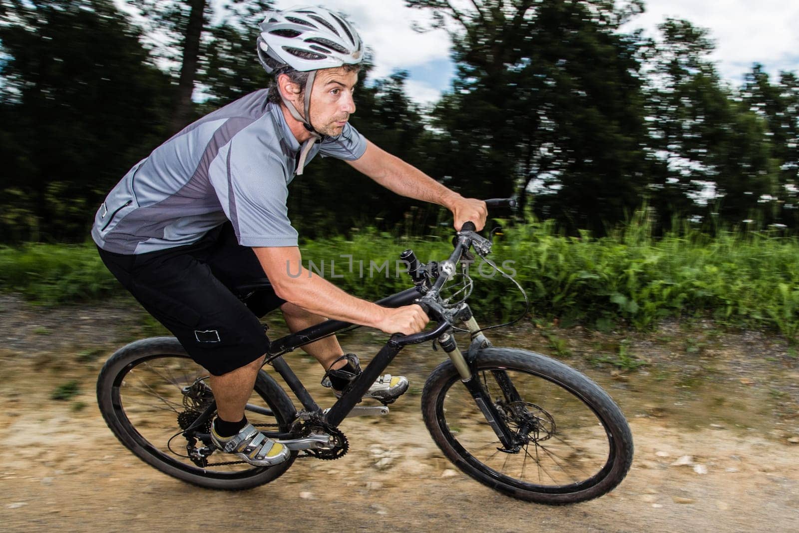 Mountain bikers in an inclined position on the downhill