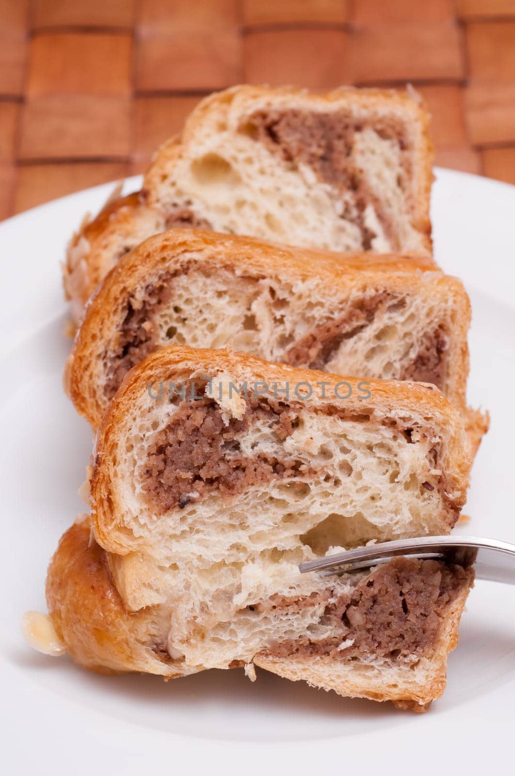 Three pieces of nut cake on a white plate