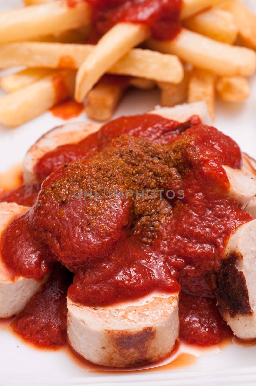 Close-up of a currywurst with sauce and curry