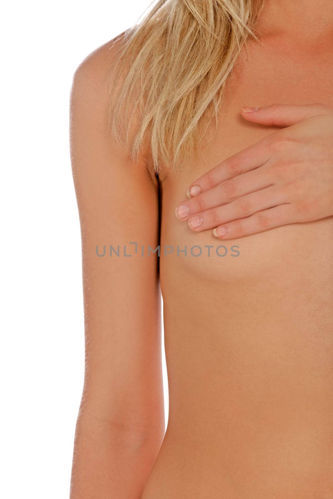 Attractive young womans chest covered by her arm isolated on a white background