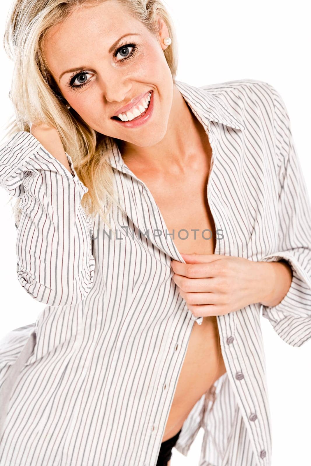 Beautiful young woman in shirt and underwear on white background