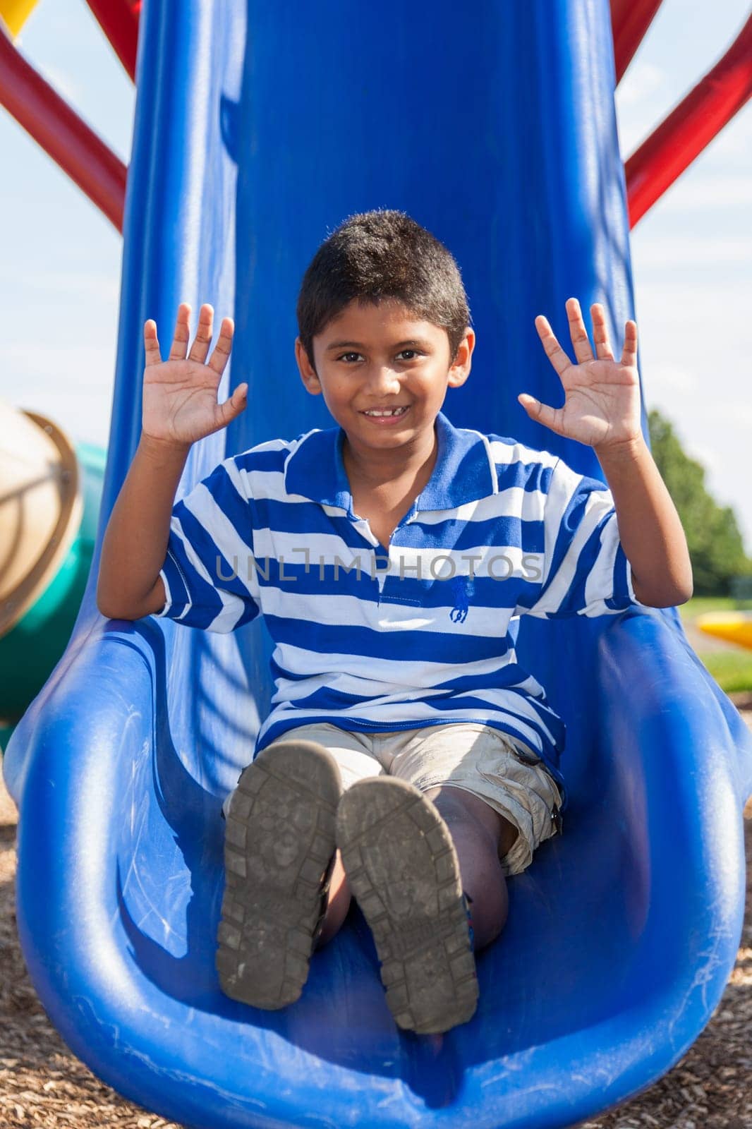 Outdoor portrait of a cute little indian boy at playground