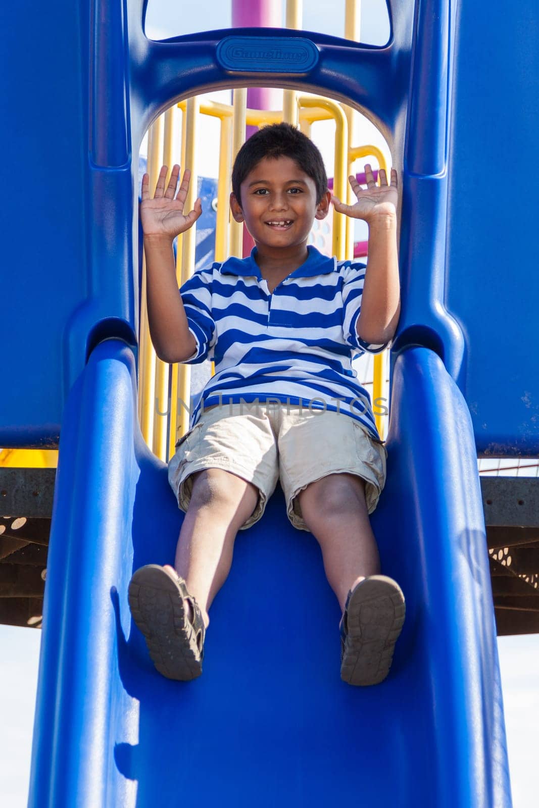 Outdoor portrait of a cute little indian boy at playground