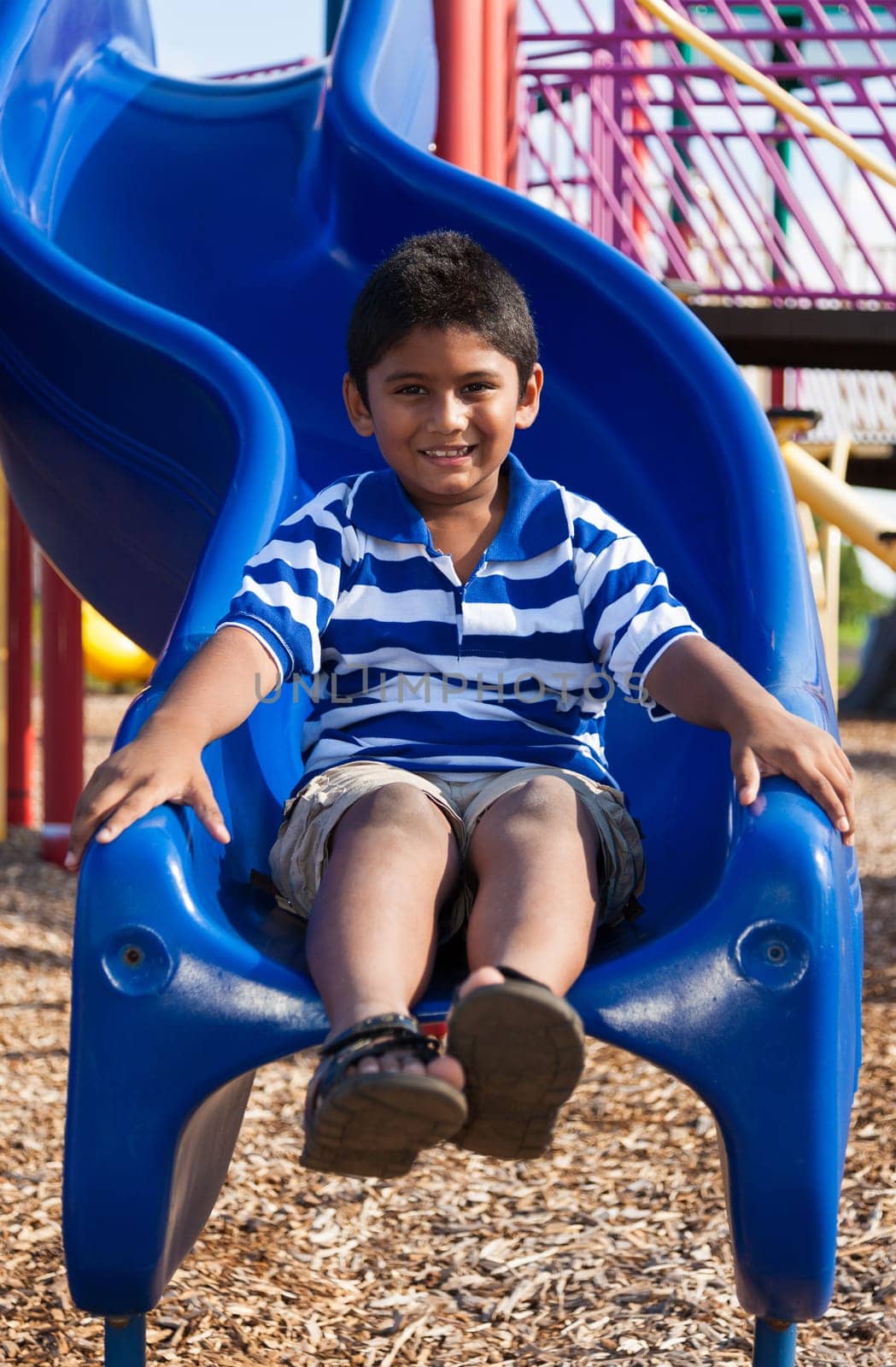 Outdoor portrait of a cute little indian boy at playground