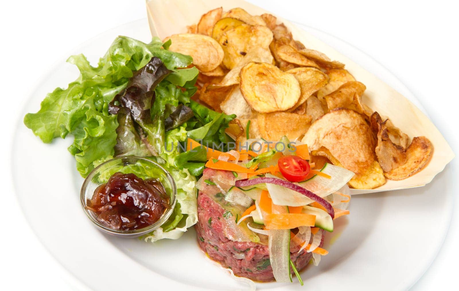 raw ground beef with chips and salad