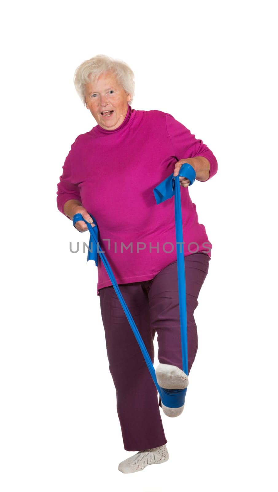 Retried overweight senior woman exercising using a strap for leverage to improve her balance and muscle coordination isolated on white