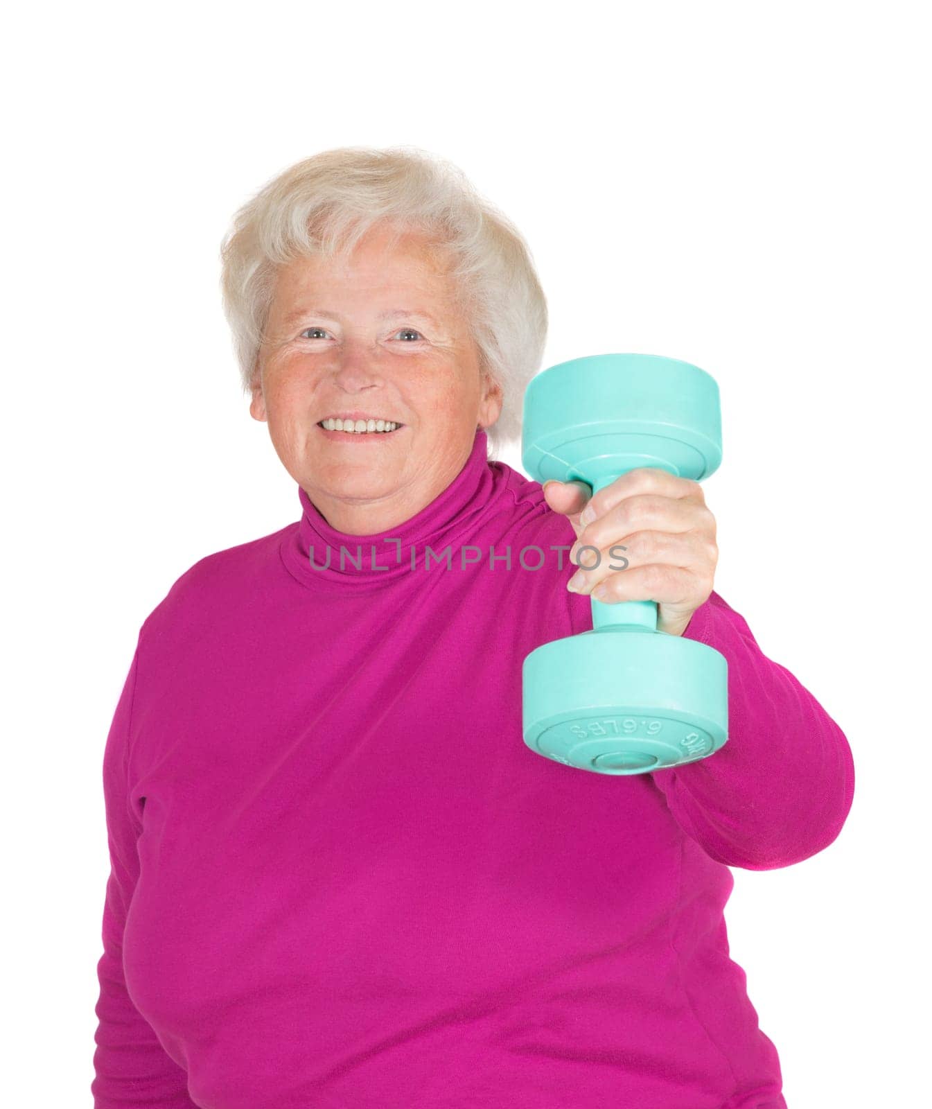 Cheerful senior woman lifting weights holding up a dumbbell in her flexed arm in a health and fitness concept