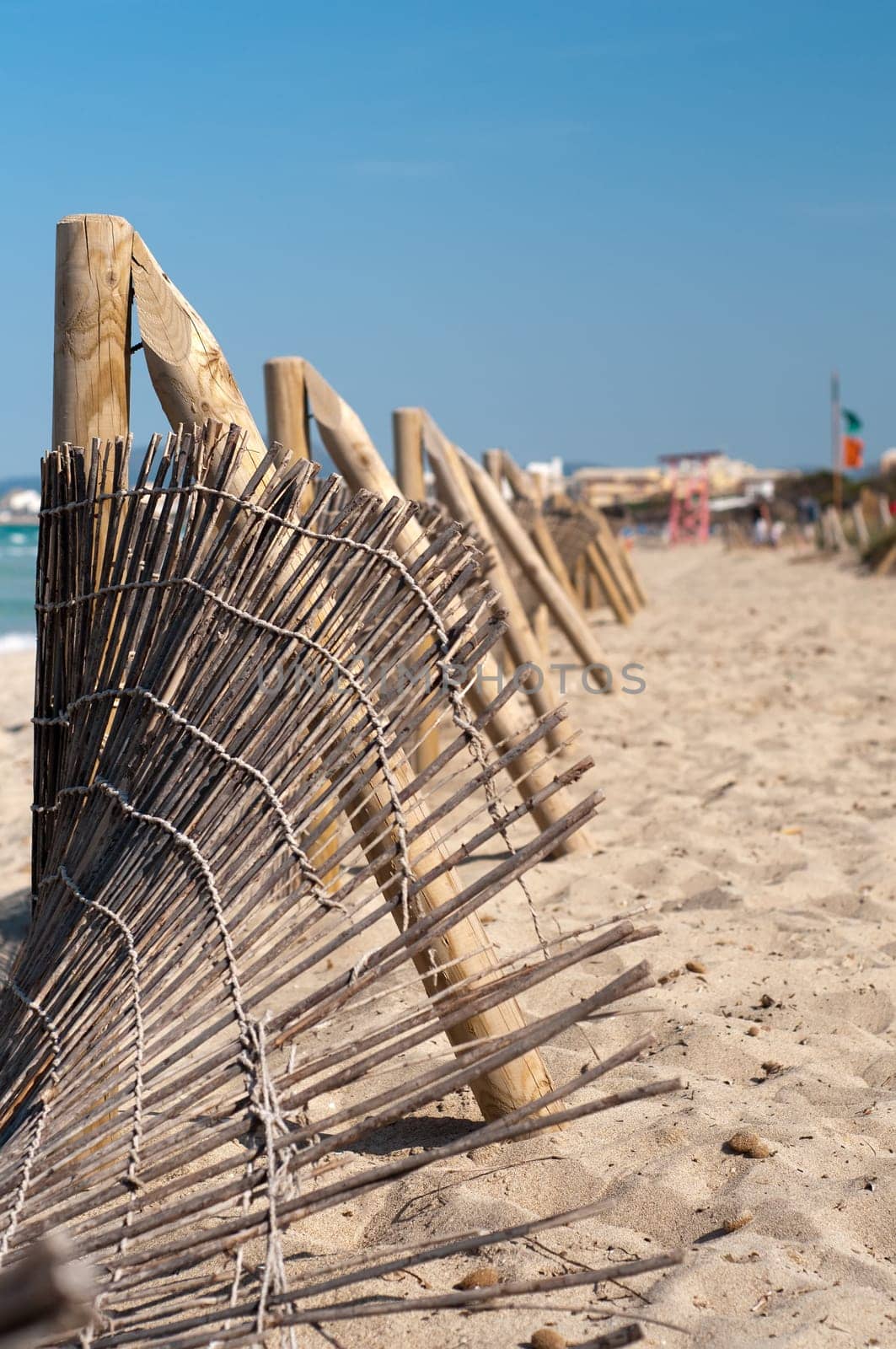 Wooden fence on the sandy beach, good weather