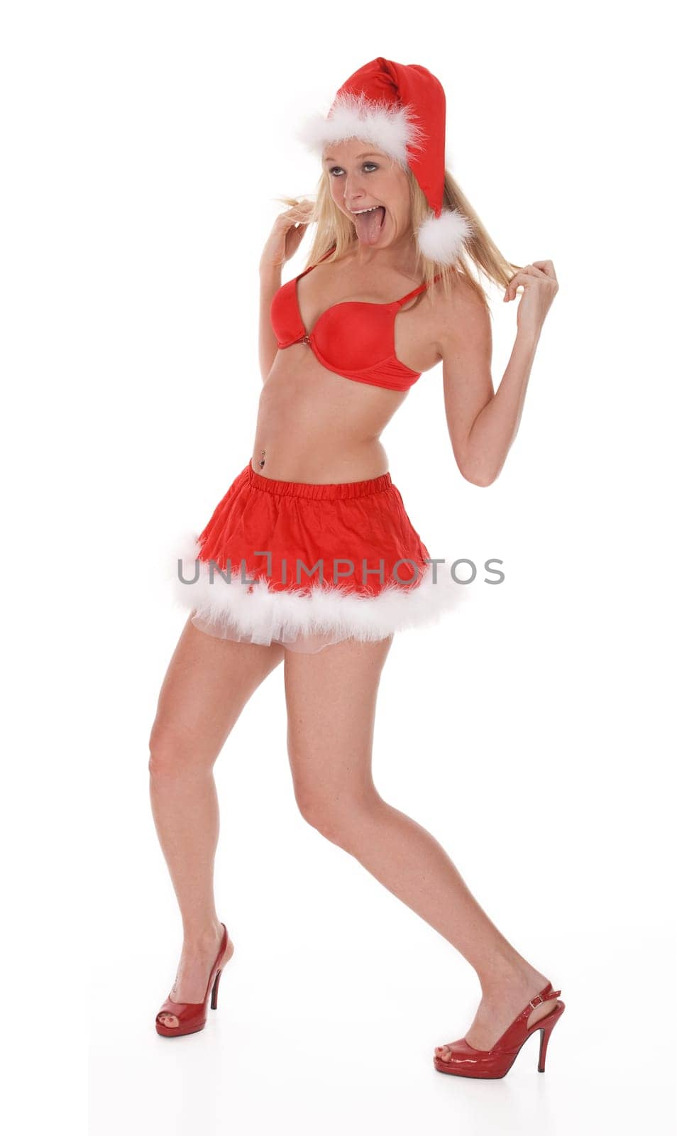 Full length view of woman dressed in sexy Santa outfit appears to be intoxicated, on white background.