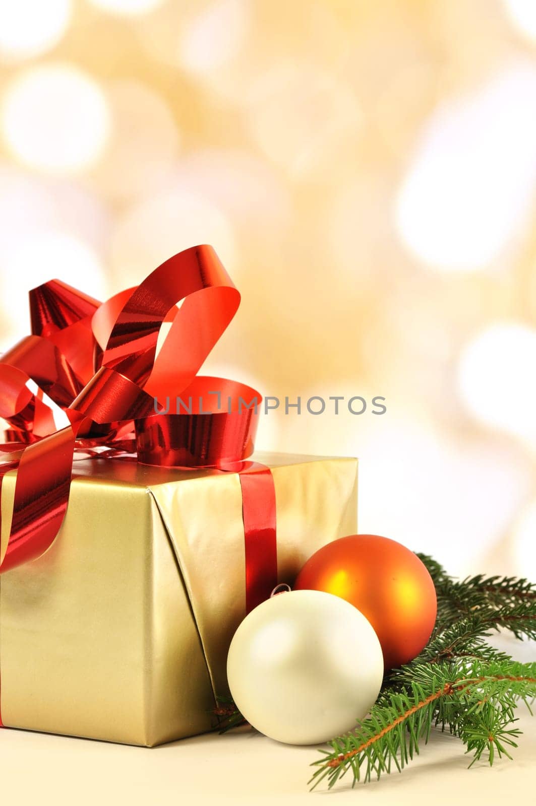 Christmas gift and baubles and bokeh in background
