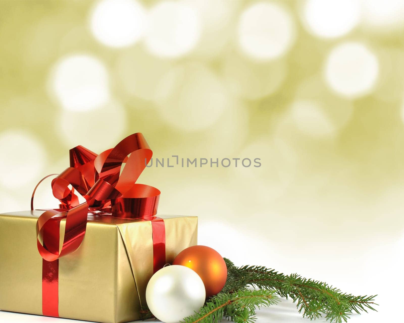Christmas gift and baubles and bokeh in background