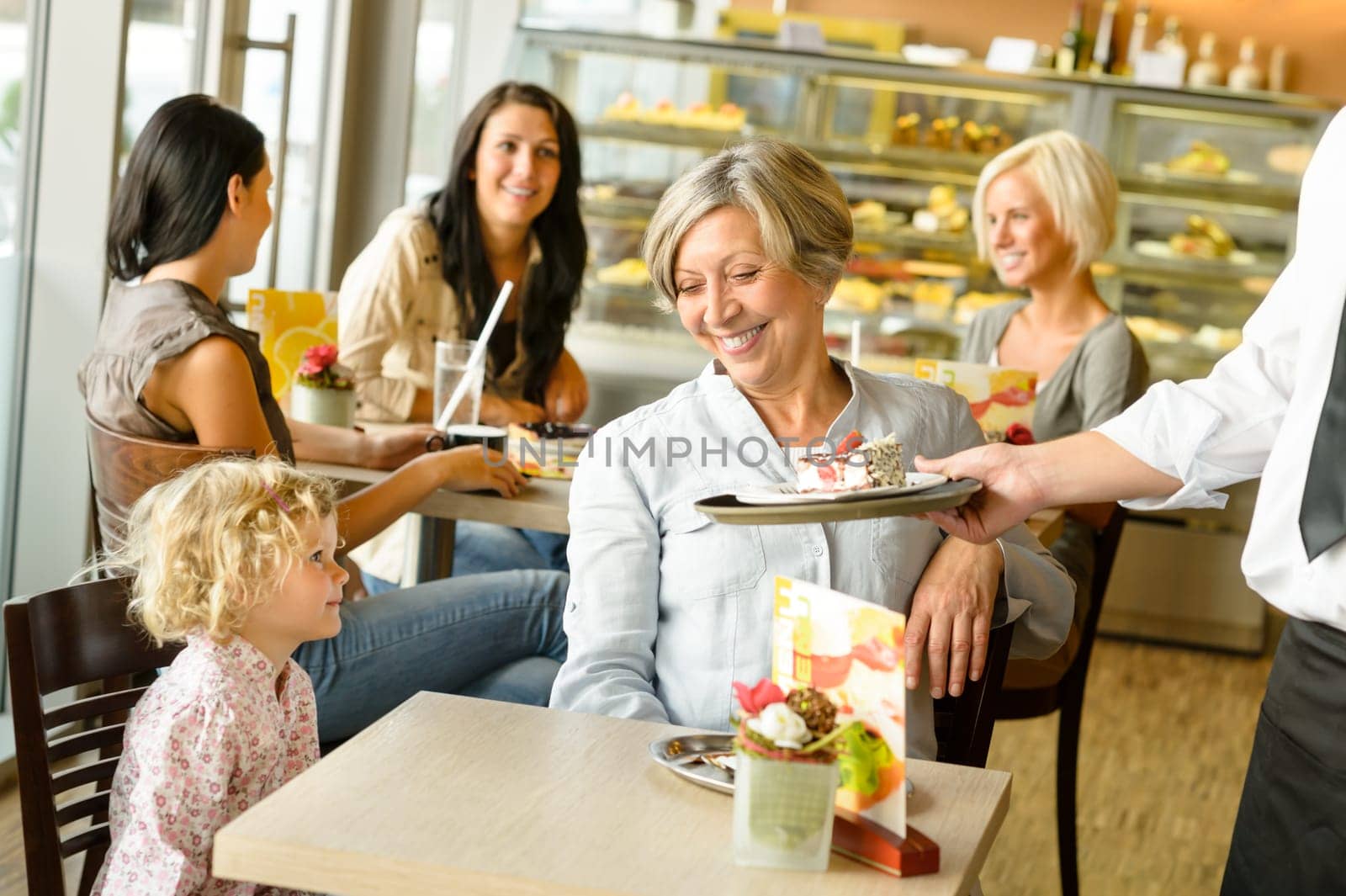 Grandmother and grandchild waiting cake order cafe dessert waiter plate