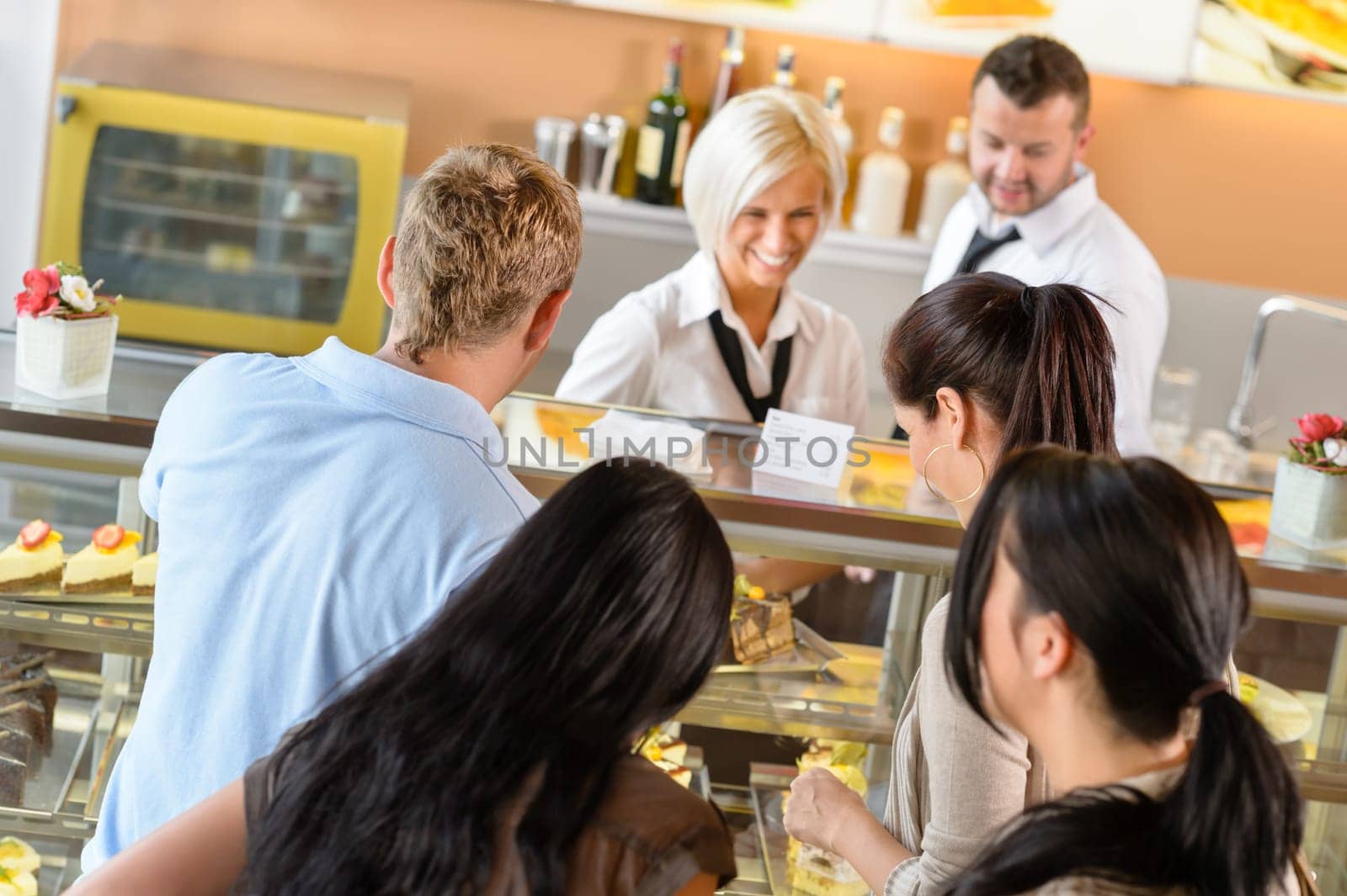 People buying cakes at cafe bar queue women display dessert