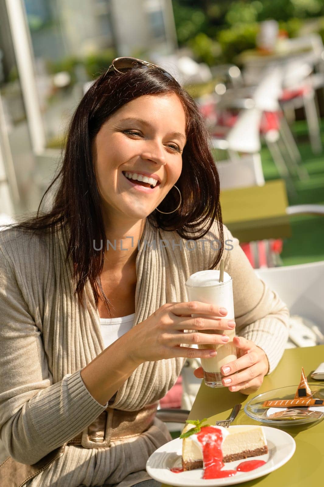 Woman at cafe bar holding latte drink smiling happy coffee