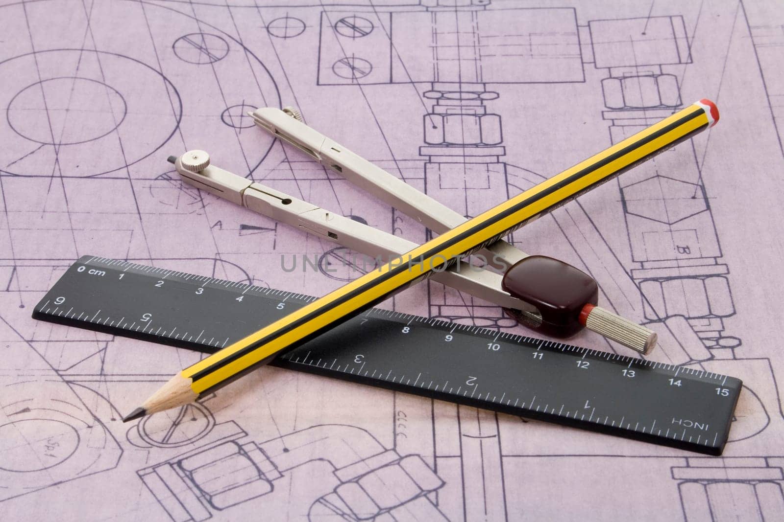 blueprint with pencil, ruler and dividers lying on it