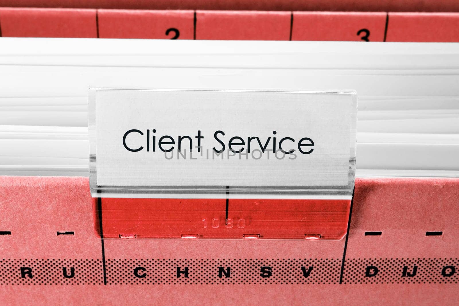 red hanging file folder labeled with client service