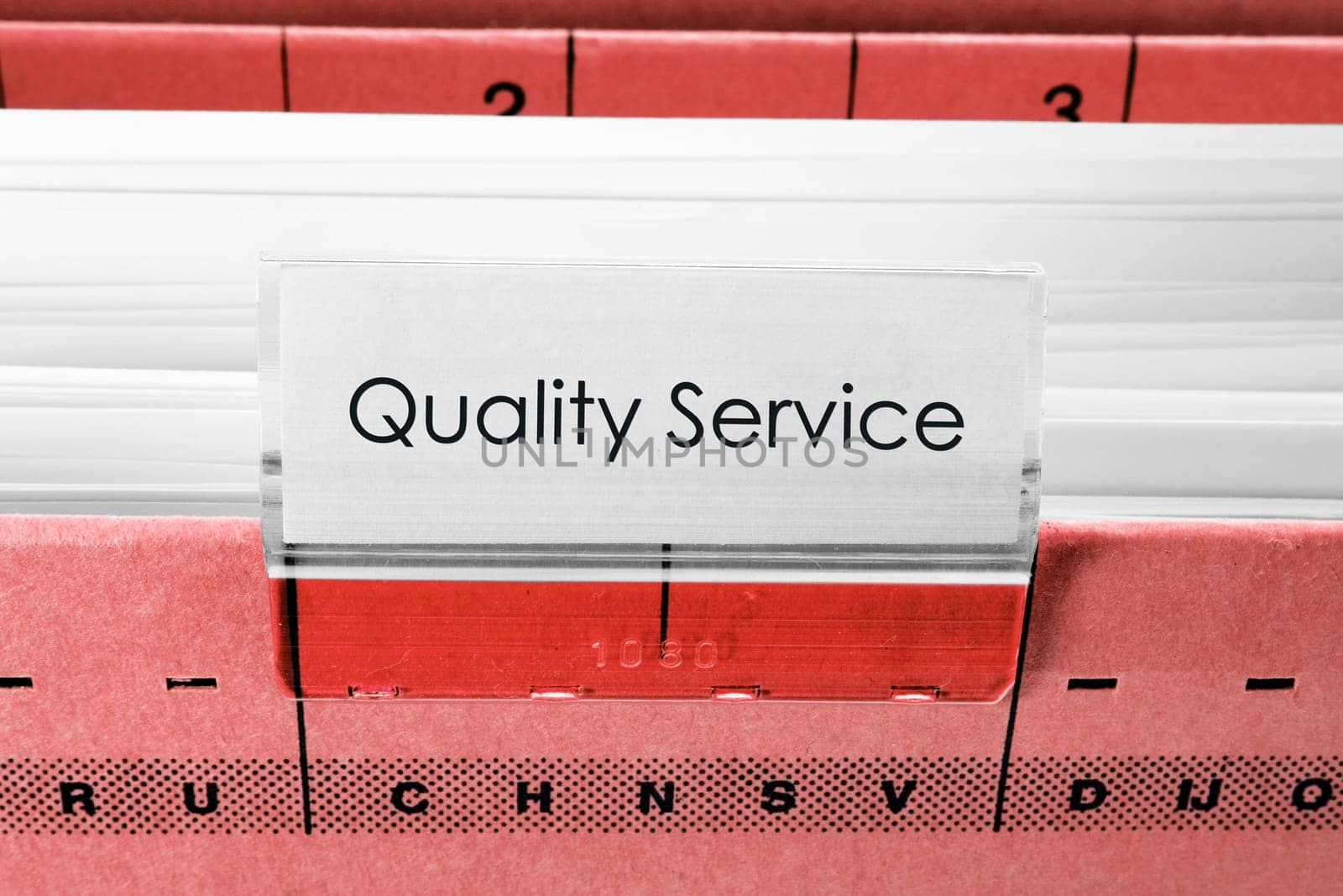 red hanging file folder labeled with quality service