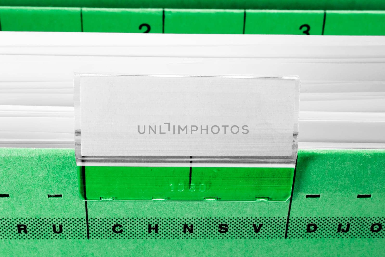 green hanging file folder with blank label