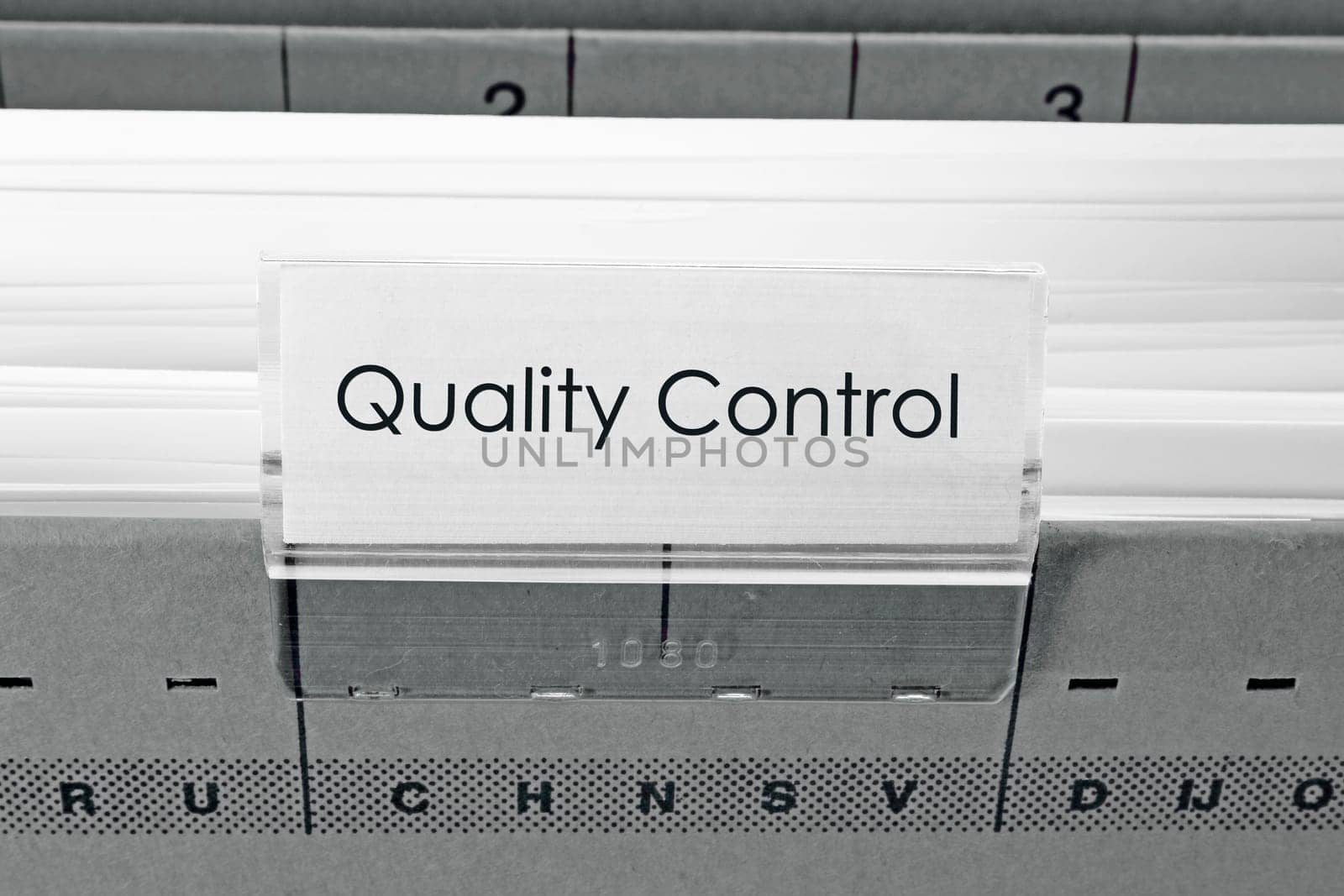 grey hanging file folder labeled with Quality Control