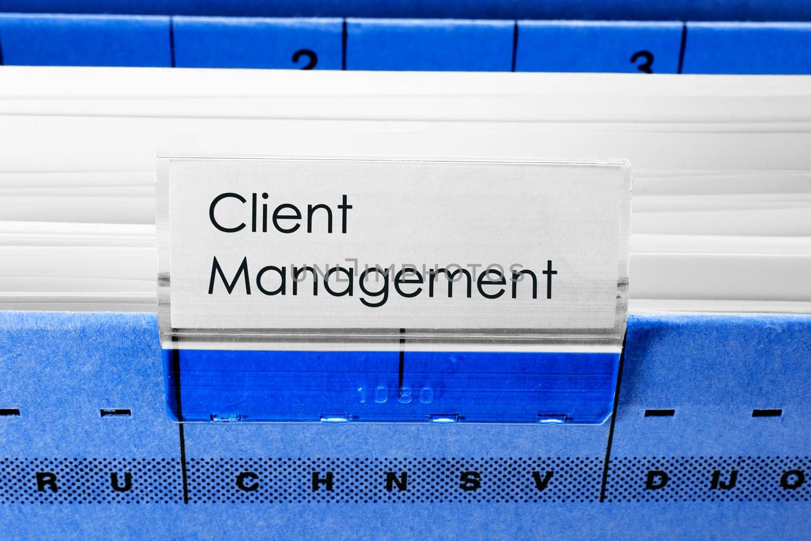 blue hanging file folder labeled with Client Management