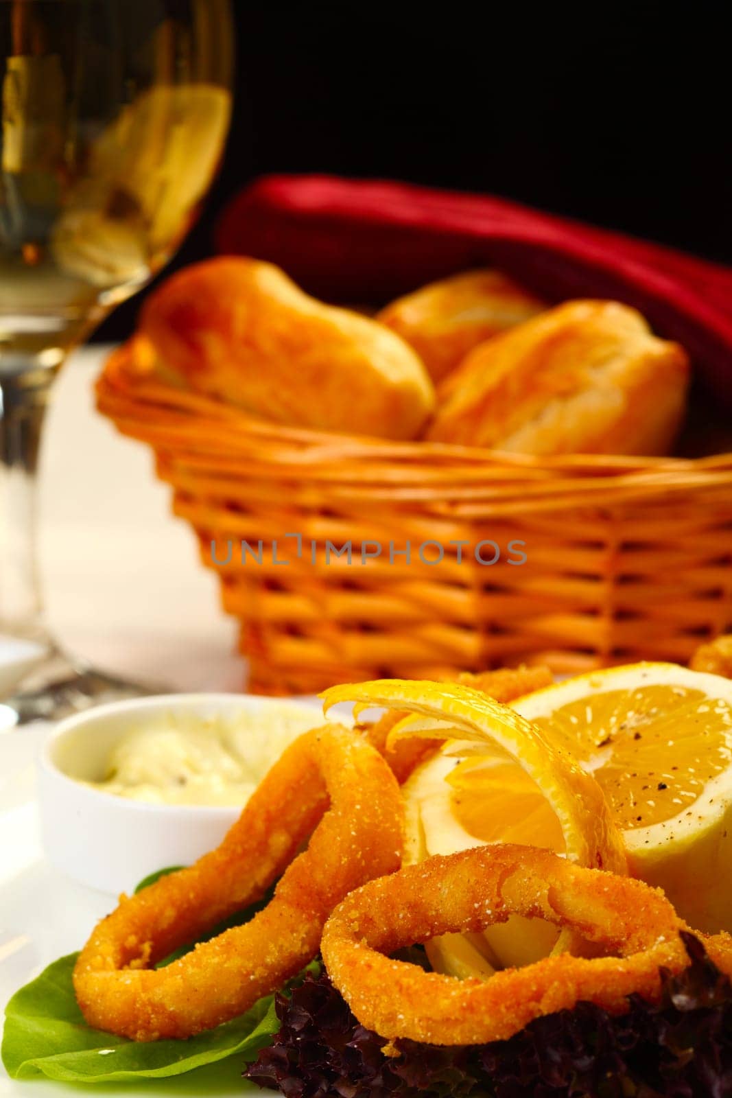 Delicious fried calamars with lemon and salad