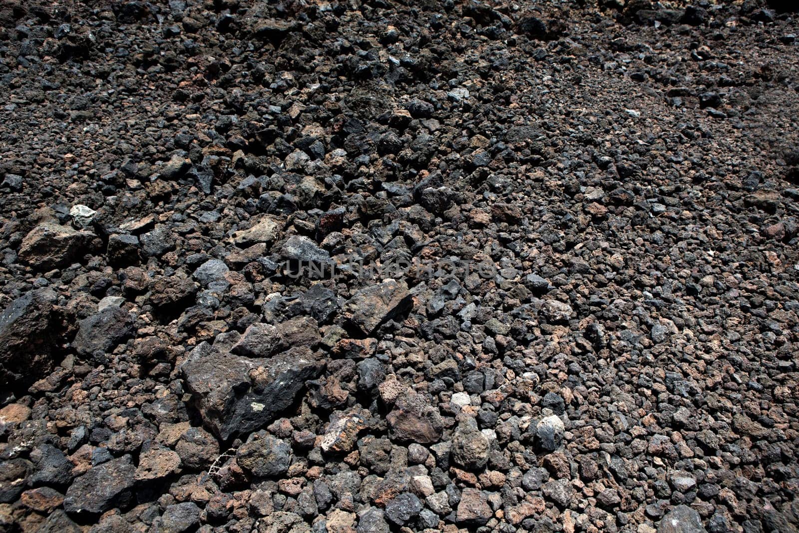 Black volcanic stones soil texture in Lanzarote